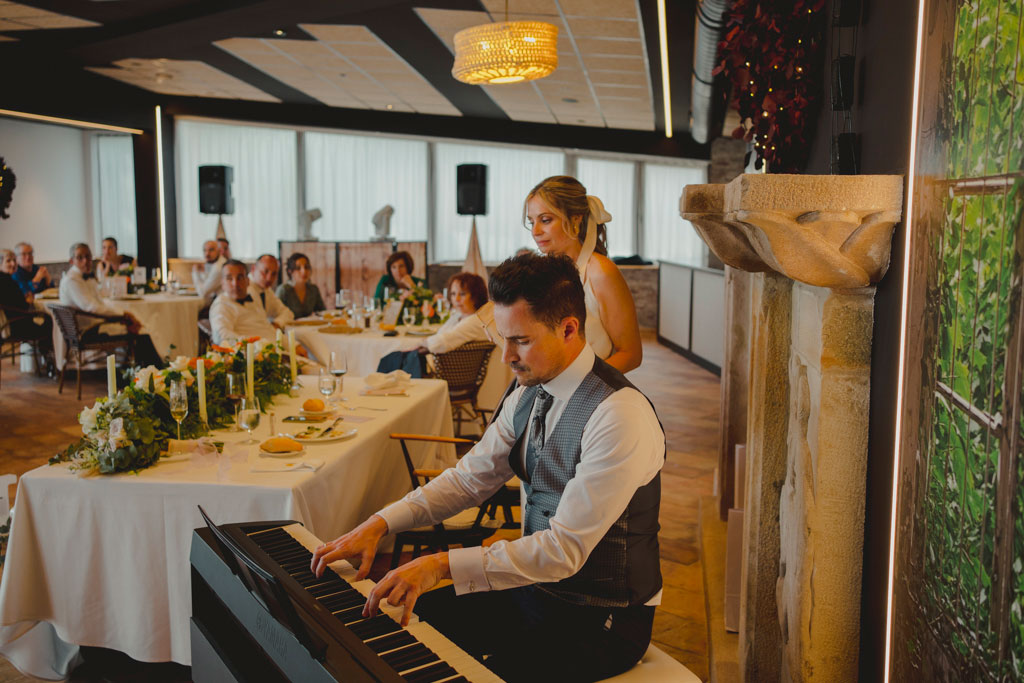 novio toca el piano en su boda